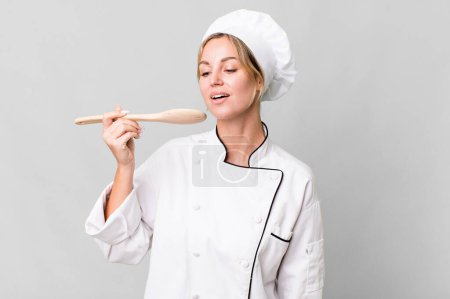 Foto de Pretty caucasian restaurant chef woman with wooden tool - Imagen libre de derechos