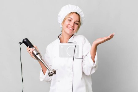 Photo for Pretty caucasian restaurant chef woman with a hand blender - Royalty Free Image