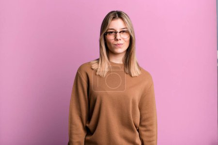 Photo for Blonde pretty woman looking proud, confident, cool, cheeky and arrogant, smiling, feeling successful - Royalty Free Image