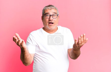 Photo for Middle age senior man open-mouthed and amazed, shocked and astonished with an unbelievable surprise - Royalty Free Image