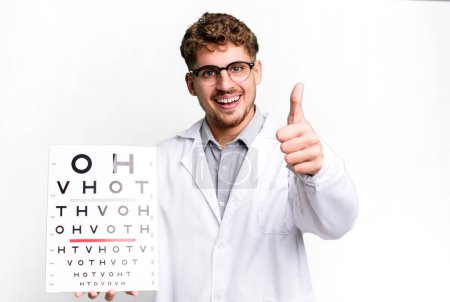 Photo for Young adult caucasian man feeling proud,smiling positively with thumbs up. optical vision test concept - Royalty Free Image