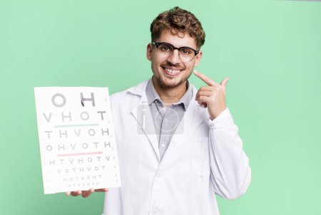 Photo for Young adult caucasian man smiling confidently pointing to own broad smile. optical vision test concept - Royalty Free Image