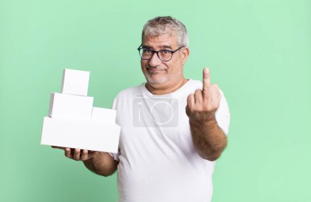 Photo for Middle age senior man feeling angry, annoyed, rebellious and aggressive. different packages blank boxes - Royalty Free Image