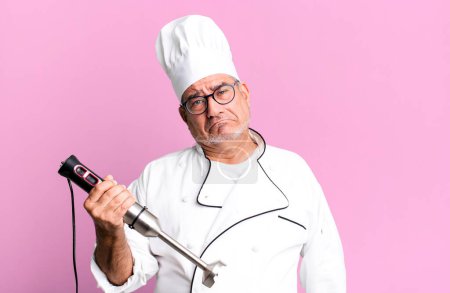 Photo for Middle age senior man feeling sad and whiney with an unhappy look and crying. restaurant chef with a tool concept - Royalty Free Image