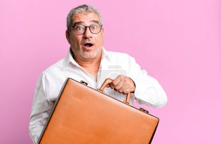 Photo for Middle age senior businessman with a suitcase - Royalty Free Image