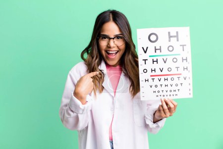 Foto de Hispanic pretty woman feeling happy and pointing to self with an excited. optometry concept - Imagen libre de derechos