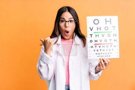 Photo for Hispanic pretty woman looking astonished in disbelief. optometry concept - Royalty Free Image
