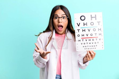 Photo for Hispanic pretty woman amazed, shocked and astonished with an unbelievable surprise. optometry concept - Royalty Free Image
