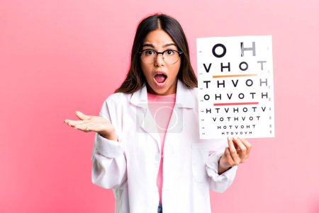 Photo for Hispanic pretty woman feeling extremely shocked and surprised. optometry concept - Royalty Free Image