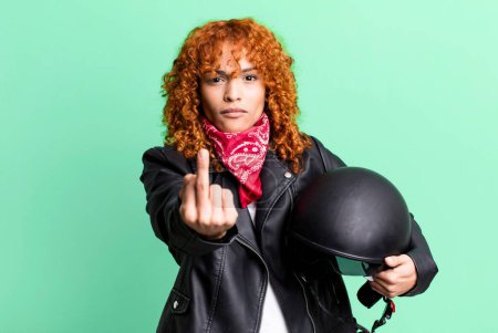 Téléchargez les photos : Red hair pretty woman feeling angry, annoyed, rebellious and aggressive. motorbike rider concept - en image libre de droit
