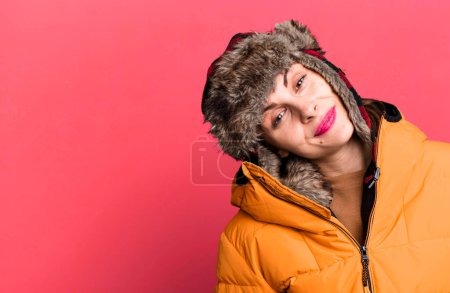 Foto de Young adult pretty woman wearing anorak and winter hat - Imagen libre de derechos