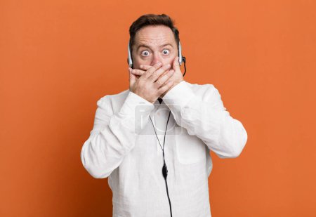 Photo for Middle age man covering mouth with hands with a shocked. telemarketer concept - Royalty Free Image