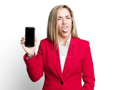 Téléchargez les photos : Pretty blonde woman feeling disgusted and irritated and tongue out. businesswoman and a phone concept - en image libre de droit