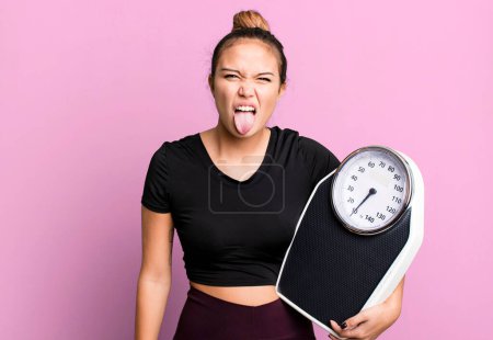 Photo for Hispanic pretty woman feeling disgusted and irritated and tongue out. fitness and diet concept - Royalty Free Image