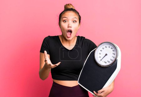 Photo for Hispanic pretty woman feeling extremely shocked and surprised. fitness and diet concept - Royalty Free Image