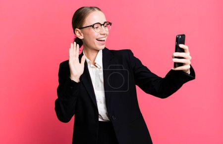 Photo for Blonde pretty young caucasian business woman using her smartphone - Royalty Free Image
