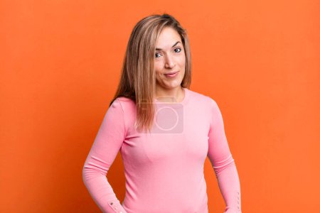 Photo for Blonde adult woman looking proud, confident, cool, cheeky and arrogant, smiling, feeling successful - Royalty Free Image