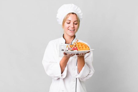 Foto de Pretty caucasian restaurant chef woman cooking waffles - Imagen libre de derechos