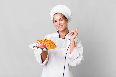 Photo for Pretty caucasian restaurant chef woman cooking waffles - Royalty Free Image
