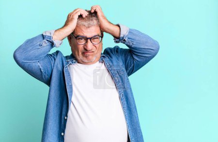 middle age senior man feeling frustrated and annoyed, sick and tired of failure, fed-up with dull, boring tasks
