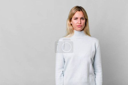 Photo for Caucasian blonde woman feeling sad and whiney with an unhappy look and crying. copy space concept - Royalty Free Image