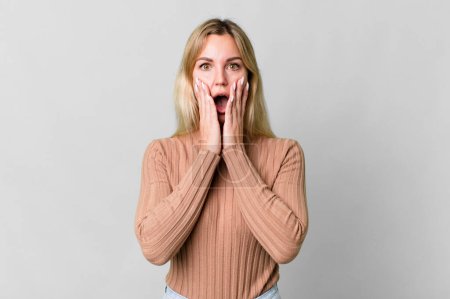 Photo for Caucasian blonde woman feeling shocked and scared - Royalty Free Image