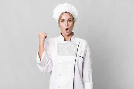Photo for Caucasian blonde woman looking astonished in disbelief. chef concept - Royalty Free Image