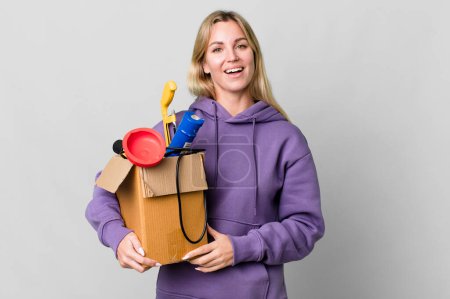 Téléchargez les photos : Caucasian blonde woman looking happy and pleasantly surprised. housekeeper concept - en image libre de droit