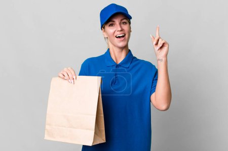 Photo for Caucasian blonde woman feeling like a happy and excited genius after realizing an idea. paper bag delivery concept - Royalty Free Image