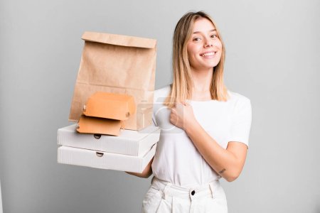 Photo for Young pretty woman feeling happy and facing a challenge or celebrating. delivery and take away food concept - Royalty Free Image
