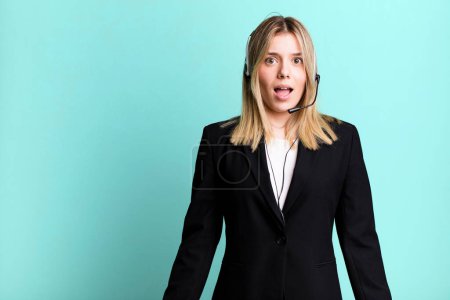 Photo for Young pretty woman looking very shocked or surprised. telemarketer concept - Royalty Free Image
