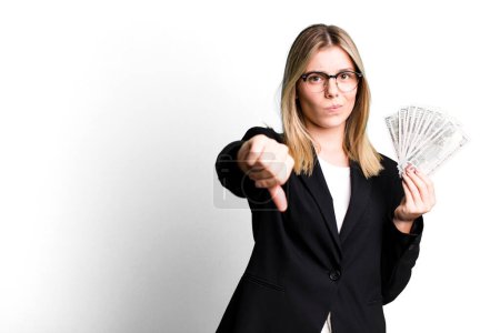 Photo for Young pretty woman feeling cross,showing thumbs down. business and money concept - Royalty Free Image