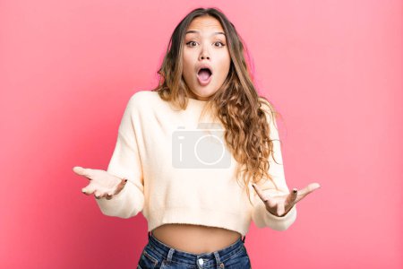 Photo for Young pretty woman feeling extremely shocked and surprised, anxious and panicking, with a stressed and horrified look - Royalty Free Image