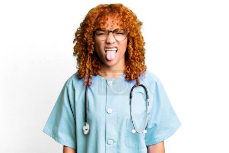 Photo for Red hair pretty woman feeling disgusted and irritated and tongue out. nurse concept - Royalty Free Image