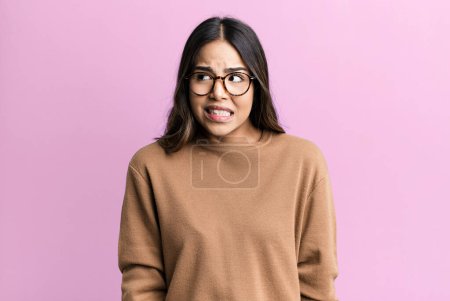 Photo for Hispanic pretty woman looking worried, stressed, anxious and scared, panicking and clenching teeth - Royalty Free Image