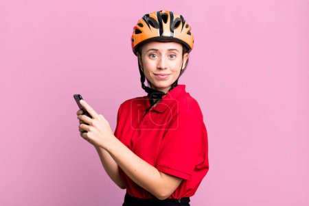 Photo for Delivery pretty blonde woman with a smartphone - Royalty Free Image