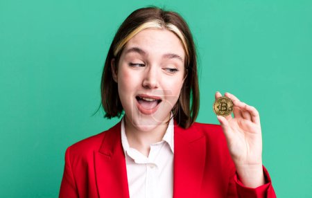 Photo for Young pretty businesswoman with a bitcoin - Royalty Free Image