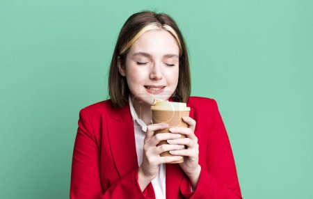 Téléchargez les photos : Young pretty businesswoman with a take away coffee - en image libre de droit