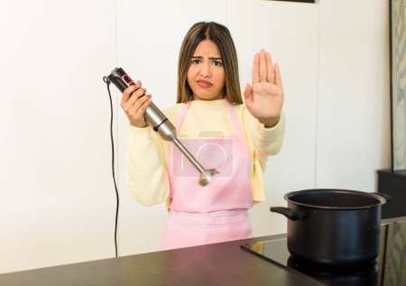 Foto de Pretty latin chef woman cooking at home - Imagen libre de derechos