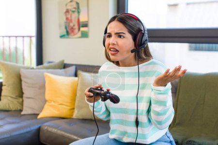 Photo for Pretty latin woman playing with headset and controller. gamer concept - Royalty Free Image