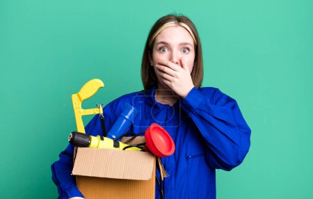 Photo for Young pretty woman covering mouth with hands with a shocked. housekeeper and toolbox concept - Royalty Free Image