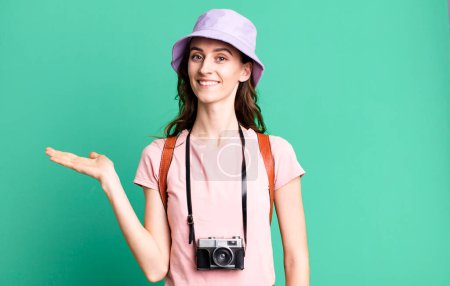 Photo for Young pretty woman smiling cheerfully, feeling happy and showing a concept. tourist concept - Royalty Free Image