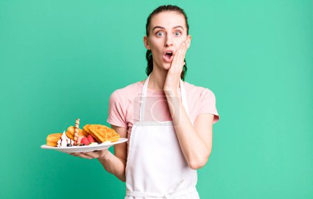 Photo for Young pretty woman feeling shocked and scared. waffles concept - Royalty Free Image