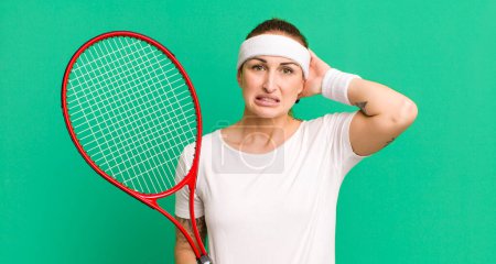 Foto de Young pretty woman feeling stressed, anxious or scared, with hands on head. tennis concept - Imagen libre de derechos