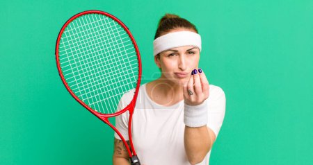 Téléchargez les photos : Young pretty woman making capice or money gesture, telling you to pay. tennis concept - en image libre de droit