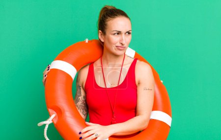 Photo for Young pretty woman feeling sad, upset or angry and looking to the side. summer and lifeguard concept - Royalty Free Image