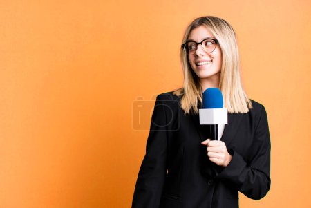 Téléchargez les photos : Young pretty journalist or presenter woman with a microphone - en image libre de droit