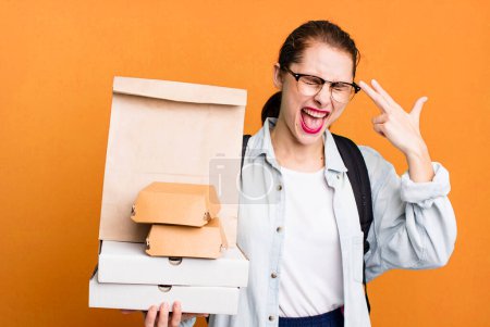 Photo for Pretty hispanic woman looking unhappy and stressed, suicide gesture making gun sign. delivery fast food take away concept - Royalty Free Image