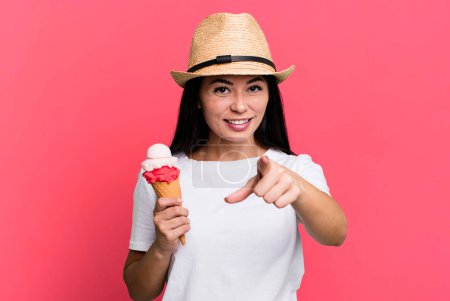 Foto de Hispanic pretty woman pointing at camera choosing you. ice cream and summer concept - Imagen libre de derechos