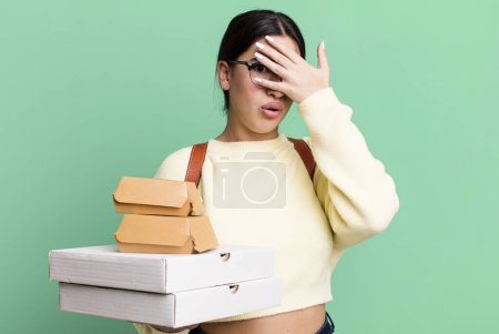 Photo for Looking shocked, scared or terrified, covering face with hand. fast food delivery or take away - Royalty Free Image